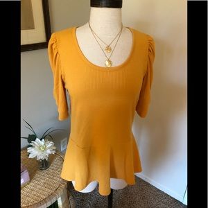 Cute pullover with peplum bottom. New with tags.